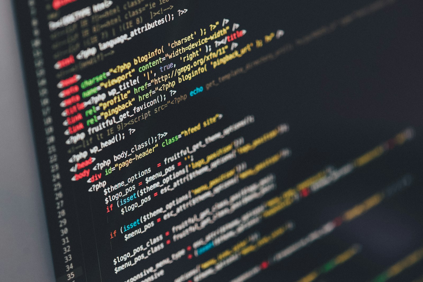 Developer workspace with code on dark screens