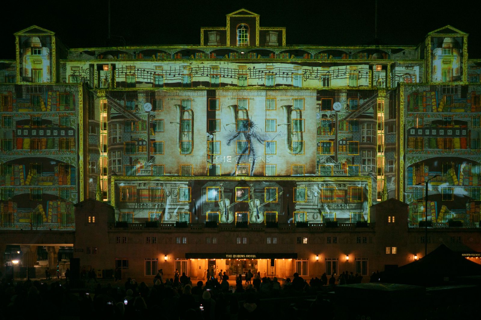 Projection-mapped visuals lighting a building façade at night